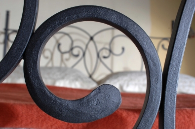 Bed with forged solid iron elements.